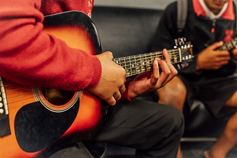 The Studio - People playing guitar.