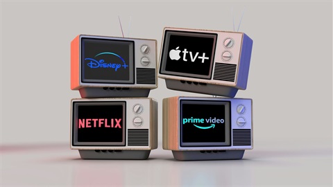 Old box TV's with streaming service logos on each of them, Netflix, Apple TV, Netflix, Prime Video.